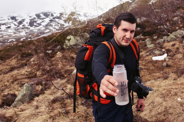 Tourist reaches out bottle with lettering 'My bottle'