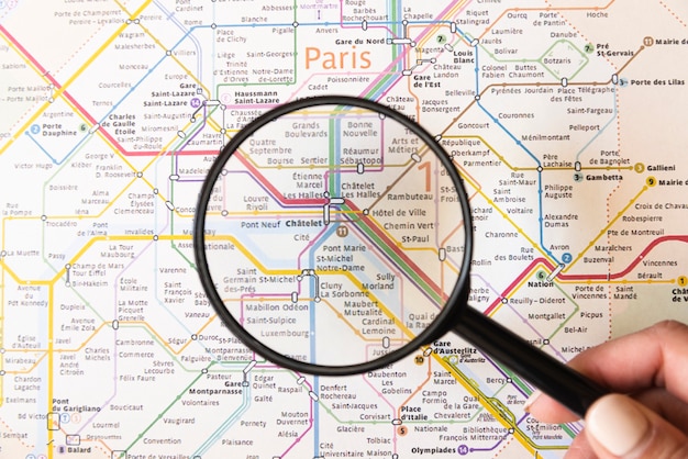 Tourist showing a place in paris with magnifying glass