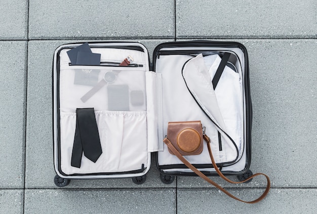 Free photo tourist suitcase sitting on ground