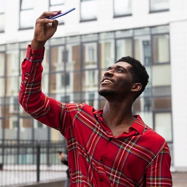 Tourist taking a selfie next to a building