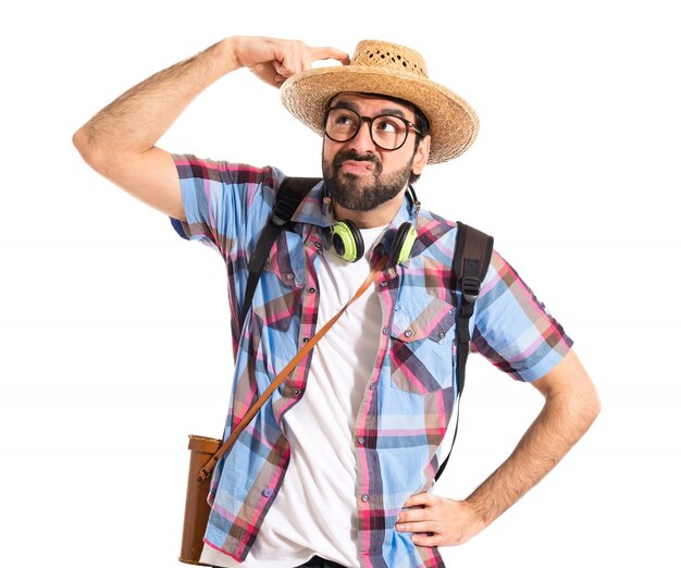 Tourist thinking over white background