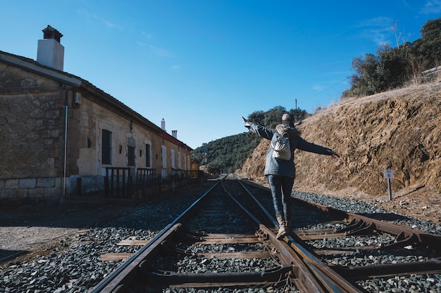 Free photo tourist walking on railway