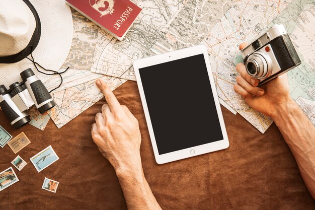 Tourist with tablet and camera navigating