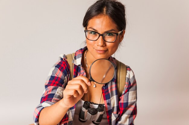 Tourist woman with magnifying glass