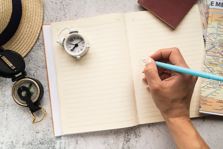 Free Photo tourist writing on a blank agenda