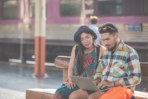 Tourists, couples looking at tablets to find attractions.