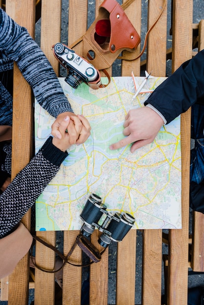 Tourists sitting with map