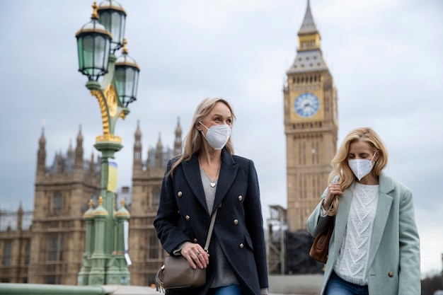 Tourists visiting city and wearing travel mask