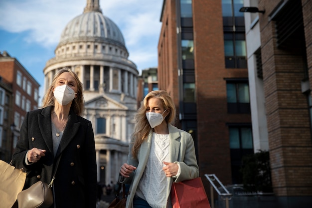 Tourists visiting city and wearing travel mask