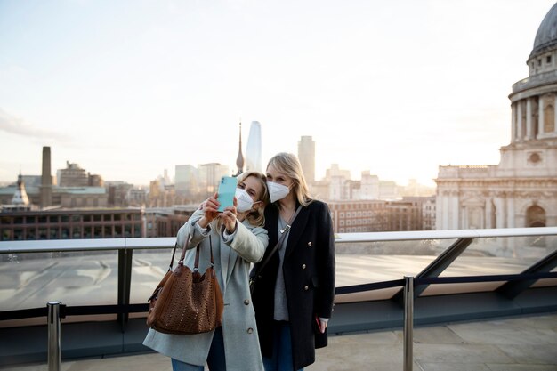 Tourists visiting city and wearing travel mask