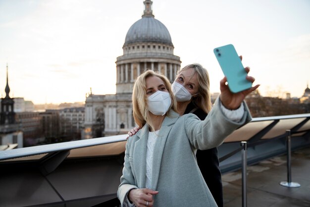 Tourists visiting city and wearing travel mask