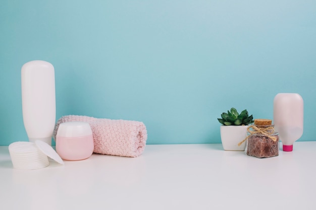 Towel and cotton pads near cosmetics bottles