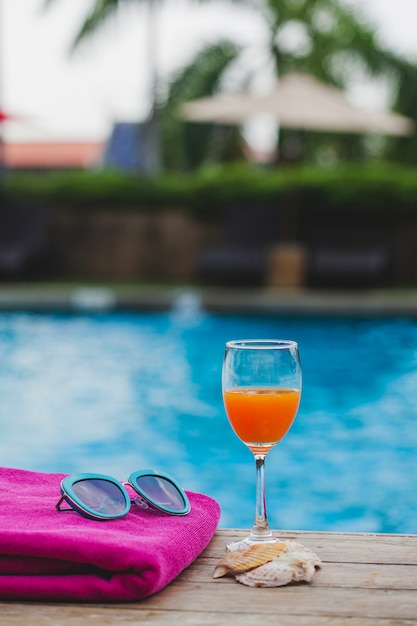 Towel with sunglasses and drink