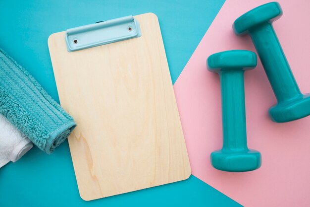 Towels, clipboard and dumbbells