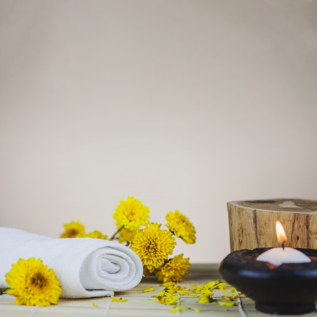 Towels, flowers, trunk and candle