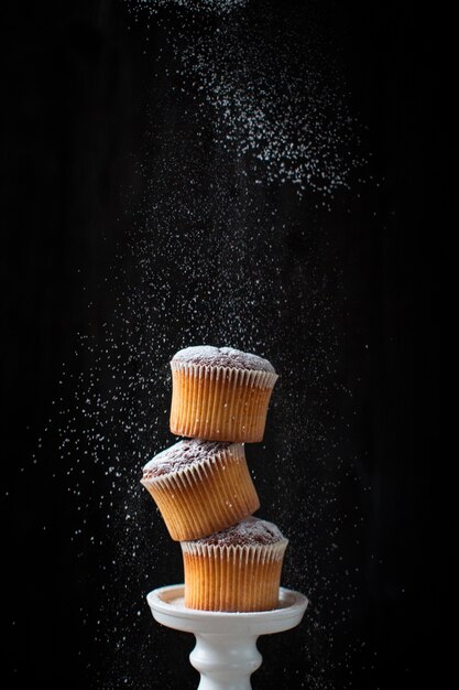 Tower of muffins with powdered sugar