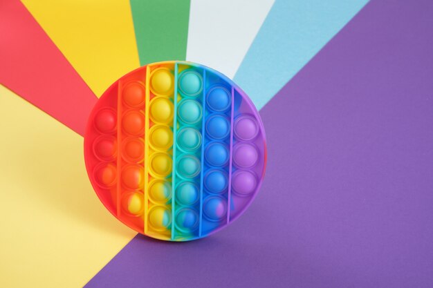 Premium Photo Toy Antistress Pop It On A Rainbow Background Fidget Toy Popping Bubbles And Calm Down