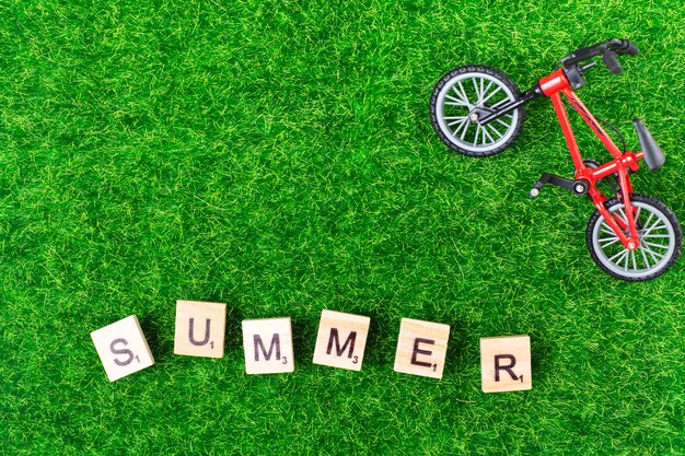 Toy bike and letters on grass