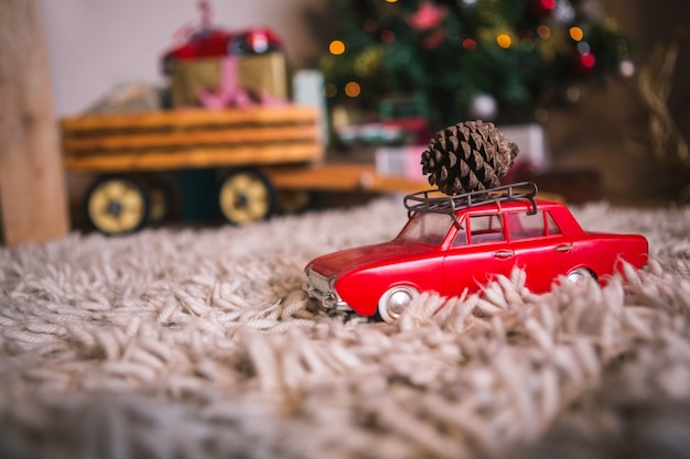 Toy car with a pine cone