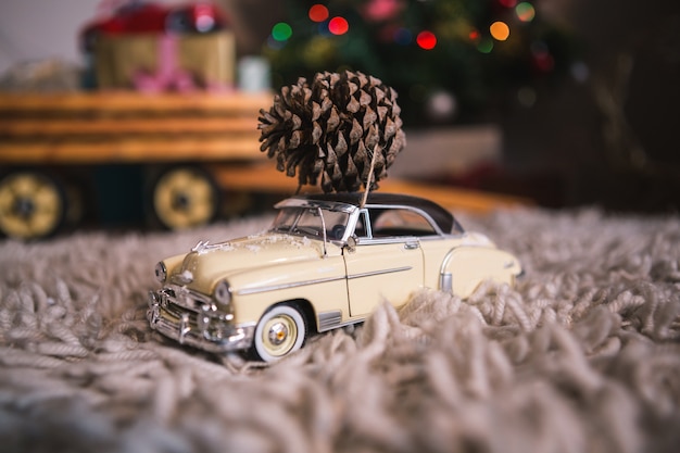 Toy car with a pinecone on top
