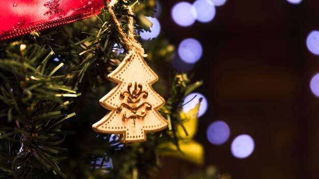 Toy fir tree hanging on Christmas tree