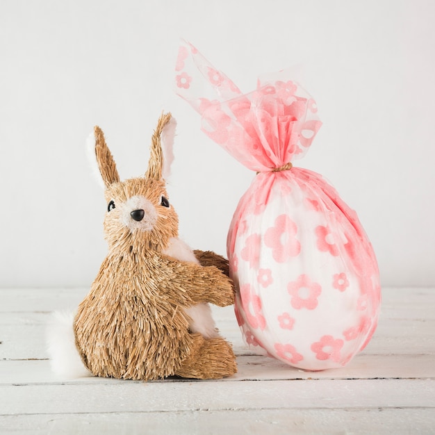 Toy rabbit near egg in pouch