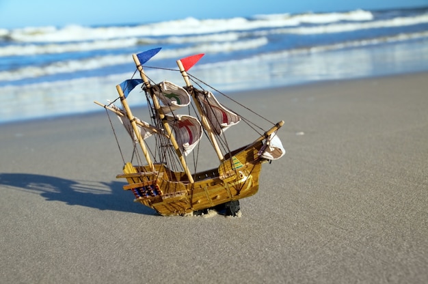 Toy ship on the seashore