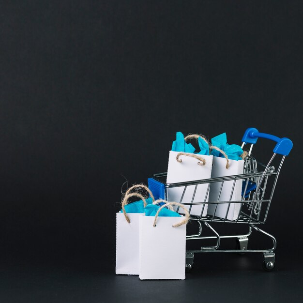 Toy shopping trolley with gifts in packets