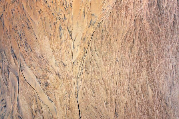 砂のテクスチャの侵食の痕跡。自然な抽象的な背景。
