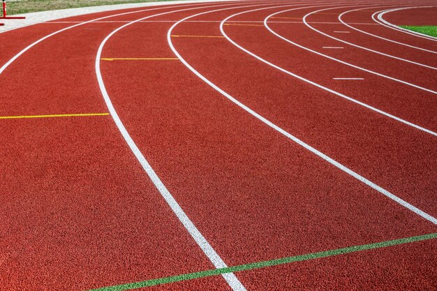 Track running. Red treadmill in sport field. Sports stadium in the open air