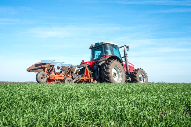 Free photo tractor cultivating field