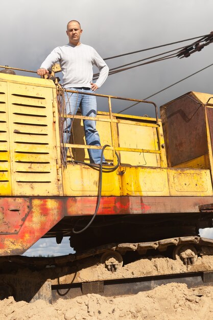 Free photo tractor operator at sand pit