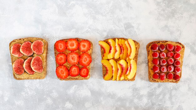 Traditional American and European summer breakfast: sandwiches of toast with peanut butter, copy  top view