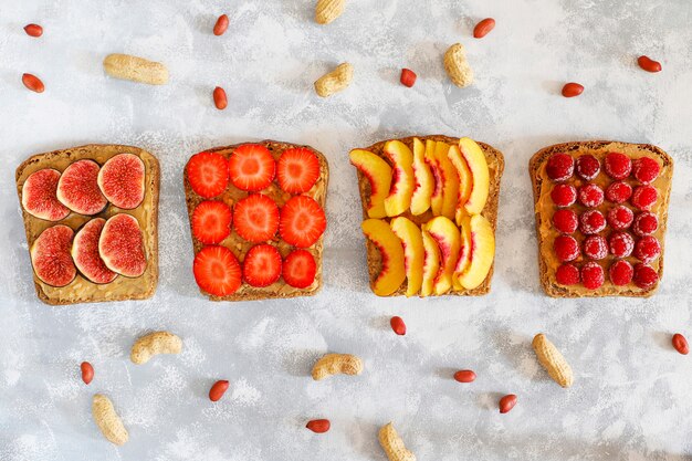 Traditional American and European summer breakfast: sandwiches of toast with peanut butter, copy  top view