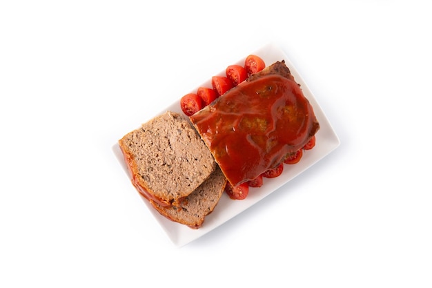 Traditional American meatloaf with ketchup isolated on white background.