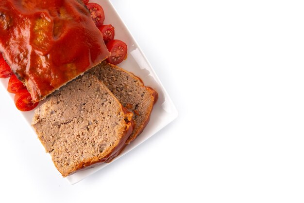 Traditional American meatloaf with ketchup isolated on white background.