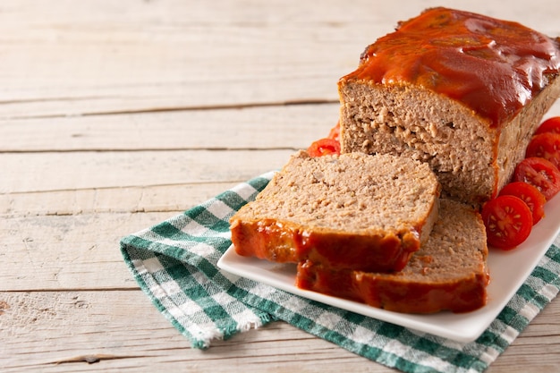 Free photo traditional american meatloaf with ketchup on rustic wooden table