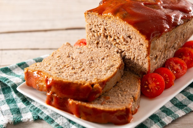 Free photo traditional american meatloaf with ketchup on rustic wooden table