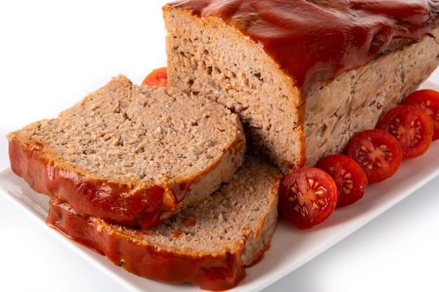 Traditional American meatloaf with ketcup isolated on white background