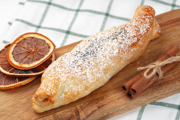 Traditional apple strudel on wooden board close up