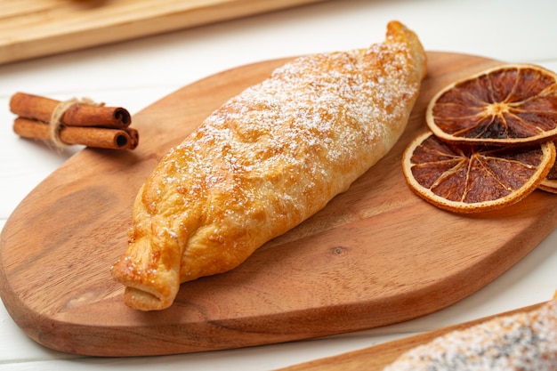 Traditional apple strudel on wooden board close up