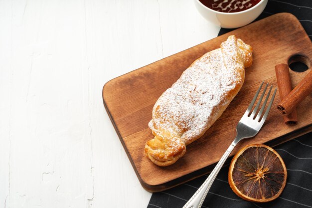 Traditional apple strudel on wooden board close up