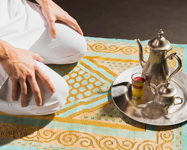 Traditional arabic hot tea and man sitting