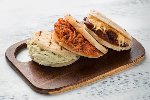 Traditional arepas on wooden board