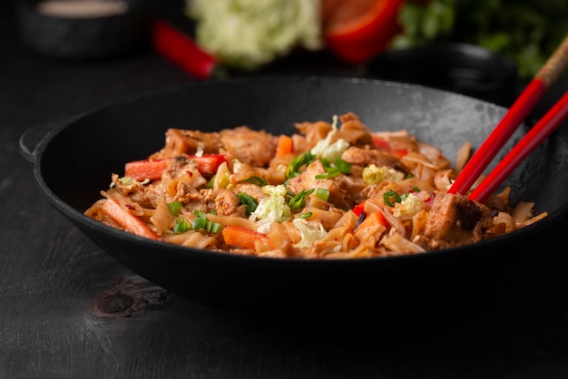 Free photo traditional asian dish with chopsticks