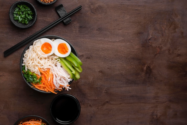 Free photo traditional asian noodles with eggs and copy space