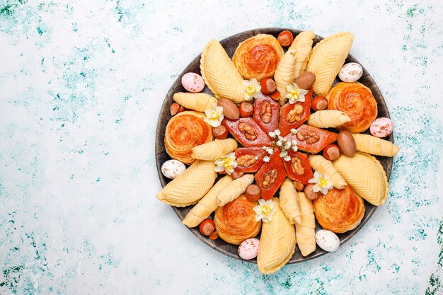 Traditional Azerbaijan holiday Novruz cookies baklavas and shakarburas on black tray plate on light