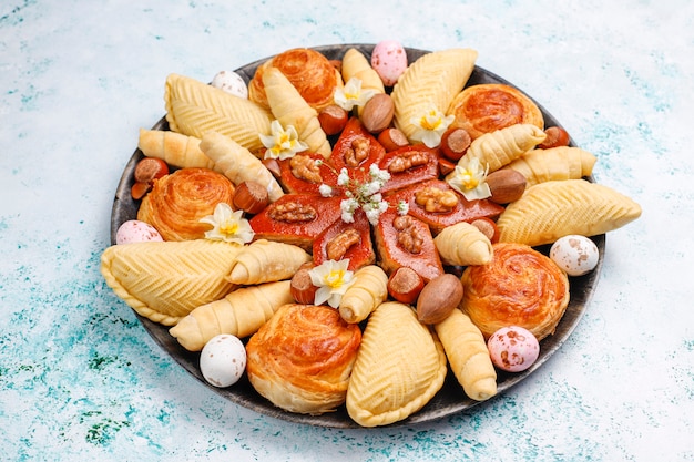 Traditional Azerbaijan holiday Novruz cookies baklavas and shakarburas on black tray plate on table