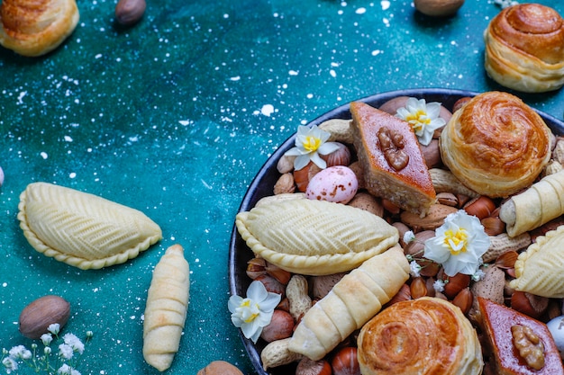 Traditional Azerbaijan holiday Novruz cookies baklavas and shakarburas on black tray plate 