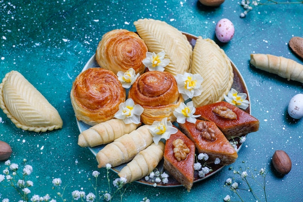 Traditional Azerbaijan holiday Novruz cookies baklavas and shakarburas on black tray plate 